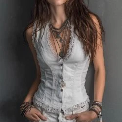 Women wearing white vintage corset vest top with lace trim neckline and sleeveless western-inspired styling